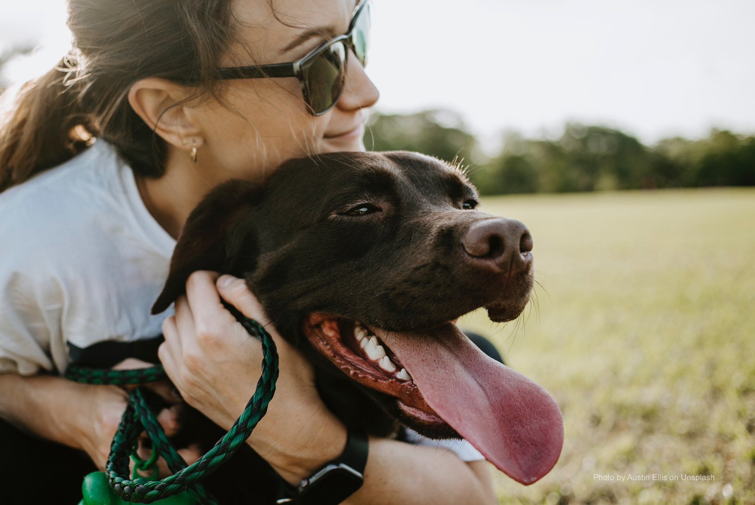 Dog owner hugging good dog